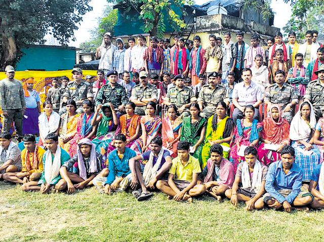 Police posing with "fake Maoists surrendering"