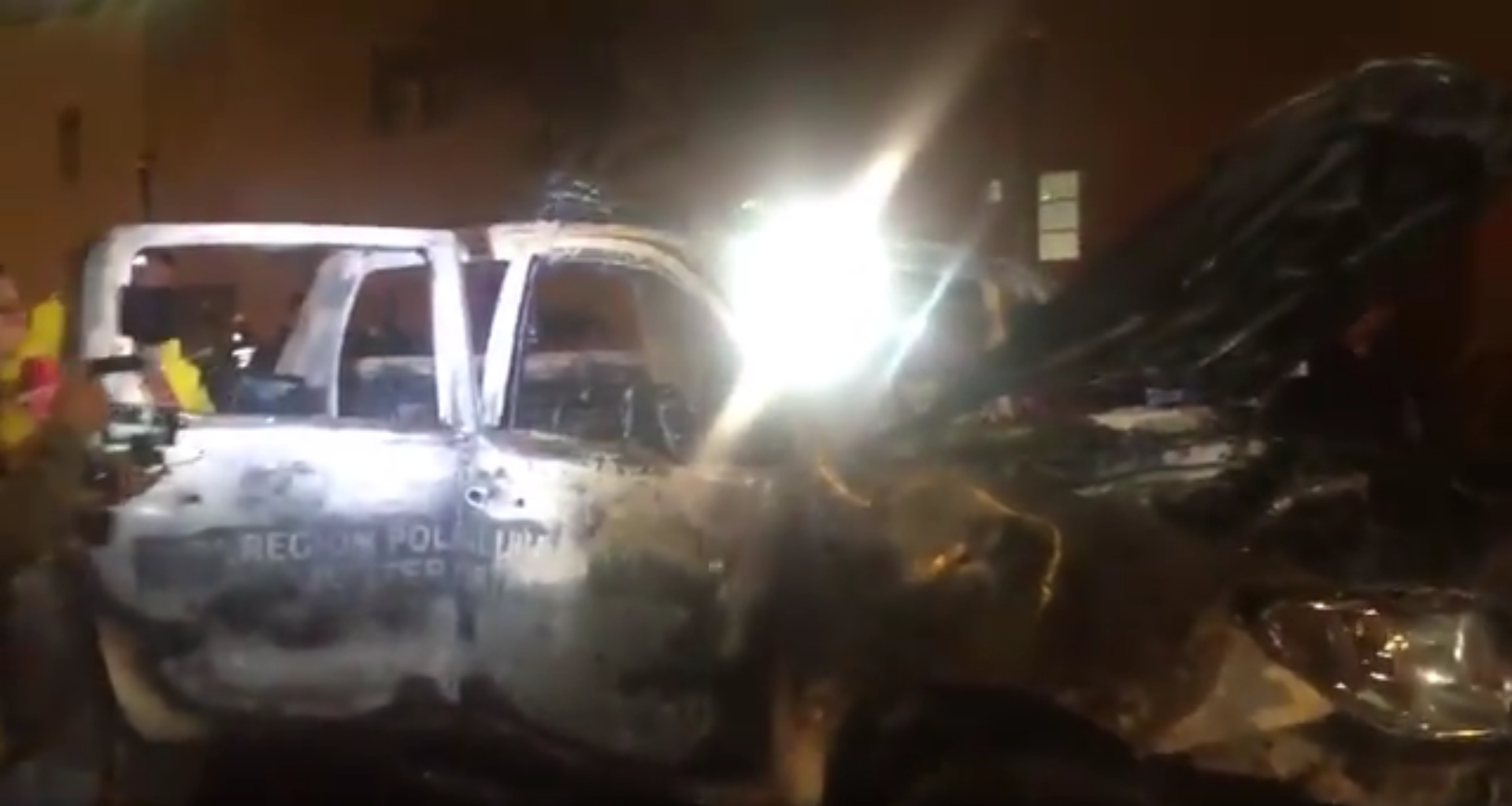 Burned down police car